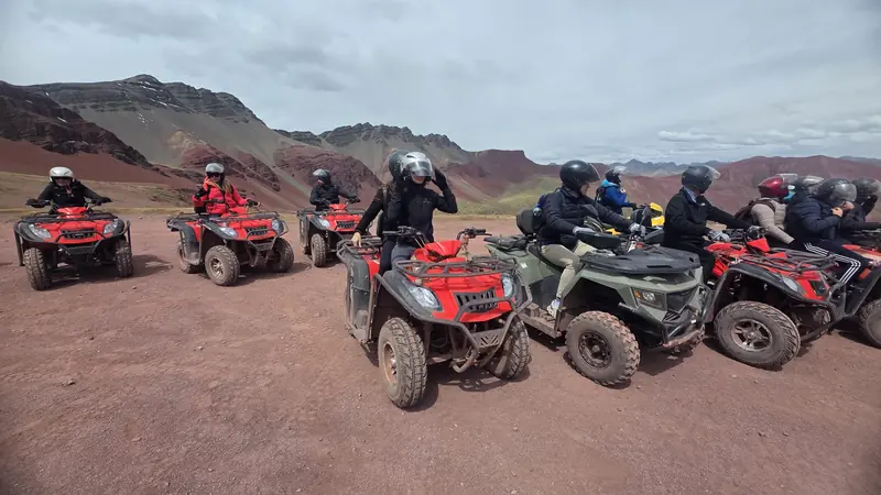 Riders on red quad bikes lined up before the run to the Red Valley